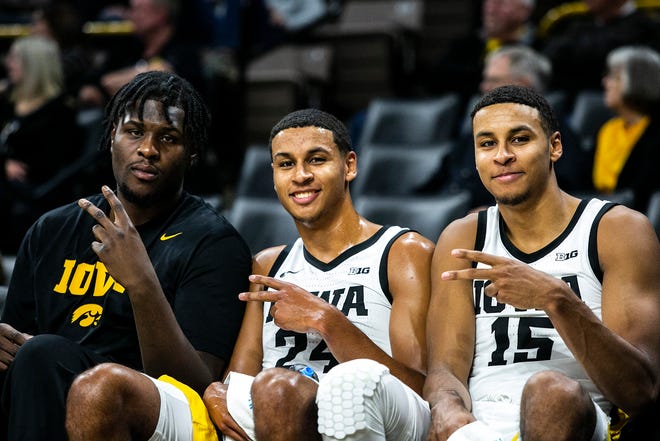 Iowa Hawkeyes players, from left, Josh Ogundele, Kris Murray and Keegan Murray pose for a photo during a NCAA non-conference men's basketball game against Longwood, Tuesday, Nov. 9, 2021, at Carver-Hawkeye Arena in Iowa City, Iowa.