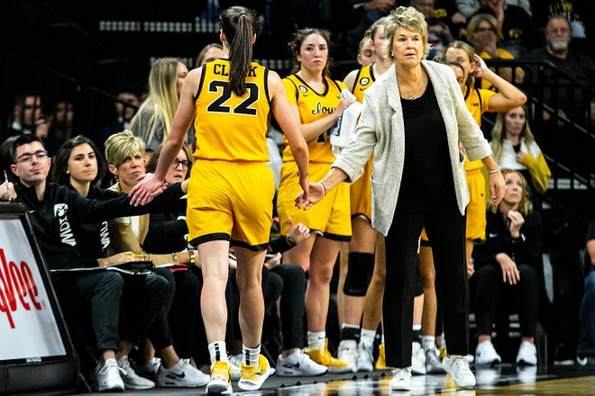 Iowa head coach Lisa Bluder greets Iowa guard Caitlin Clark (22) as she goes to the bench during a NCAA non-conference women's basketball game against New Hampshire, Tuesday, Nov. 9, 2021, at Carver-Hawkeye Arena in Iowa City, Iowa.