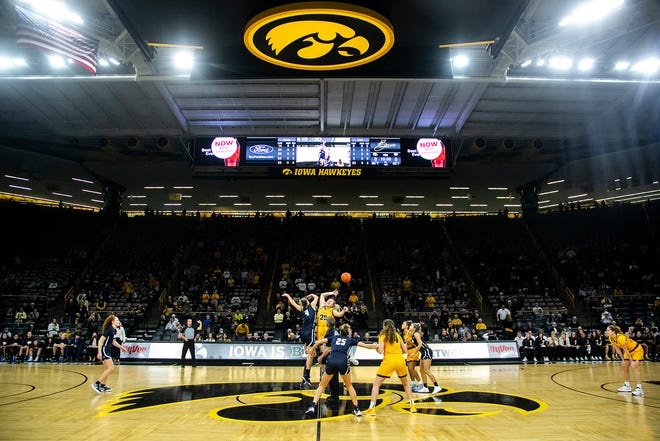 Iowa center Monika Czinano, right, wins the opening tip off against New Hampshire's Ivy Gogolin during a NCAA non-conference women's basketball game, Tuesday, Nov. 9, 2021, at Carver-Hawkeye Arena in Iowa City, Iowa.