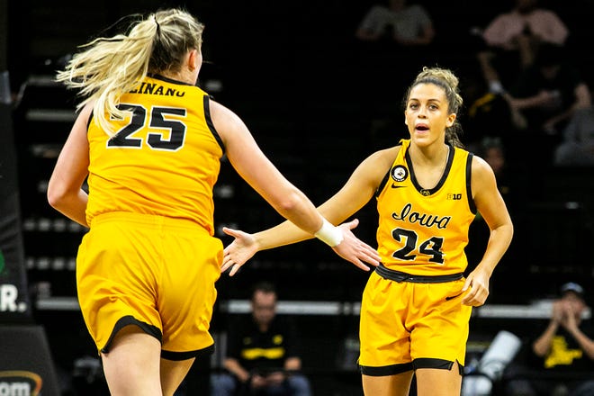Iowa guard Gabbie Marshall (24) gets a high-five from Iowa center Monika Czinano (25) after making a basket during a NCAA non-conference women's basketball game against New Hampshire, Tuesday, Nov. 9, 2021, at Carver-Hawkeye Arena in Iowa City, Iowa.