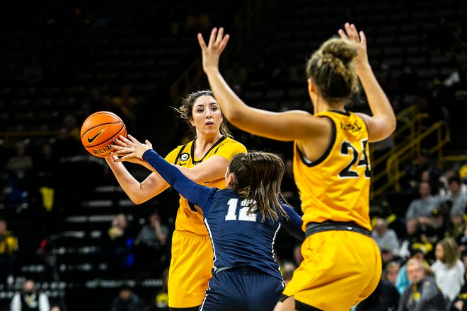Iowa's McKenna Warnock looks to pass as New Hampshire's Adara Groman (12) defends during a NCAA non-conference women's basketball game, Tuesday, Nov. 9, 2021, at Carver-Hawkeye Arena in Iowa City, Iowa.
