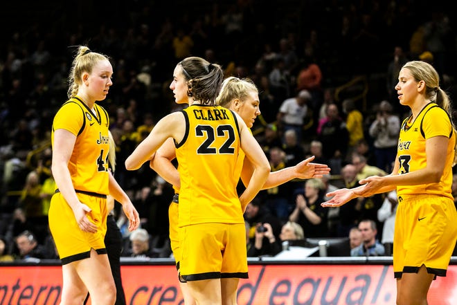 Iowa guard Caitlin Clark (22) greets teammate Addison O'Grady, left, after a NCAA non-conference women's basketball game against New Hampshire, Tuesday, Nov. 9, 2021, at Carver-Hawkeye Arena in Iowa City, Iowa.