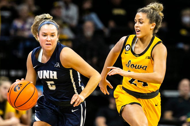 New Hampshire's Amanda Torres (5) dribbles the ball up court as Iowa guard Gabbie Marshall defends during a NCAA non-conference women's basketball game, Tuesday, Nov. 9, 2021, at Carver-Hawkeye Arena in Iowa City, Iowa.