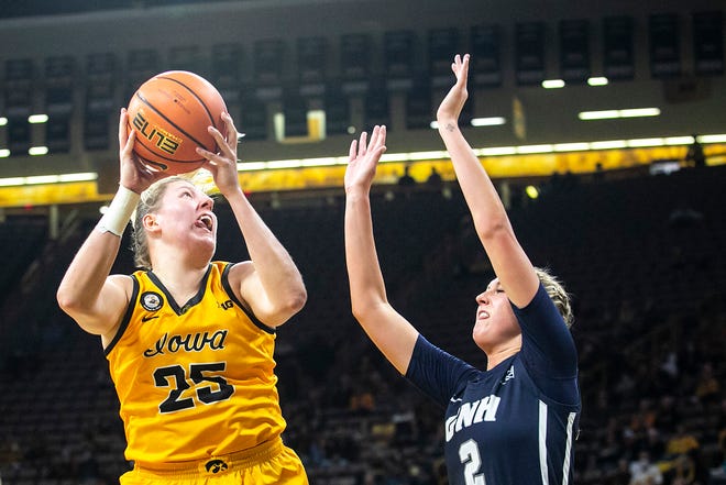 Iowa center Monika Czinano (25) shoot a basket as New Hampshire's Brooke Kane (2) defends during a NCAA non-conference women's basketball game, Tuesday, Nov. 9, 2021, at Carver-Hawkeye Arena in Iowa City, Iowa.