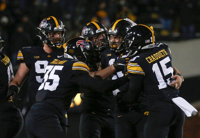 Members of the Iowa Hawkeyes defense celebrate after junior Joe Evans made the game-ending tackle against Minnesota during the NCAA Big 10 conference football game on Saturday, Nov. 13, 2021, at Kinnick Stadium in Iowa City, Iowa.