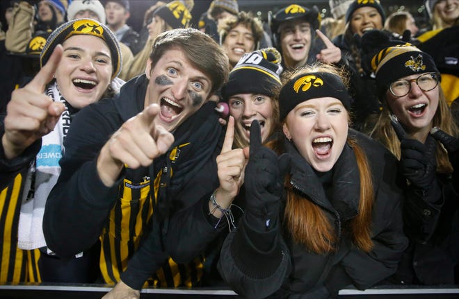 Iowa Hawkeyes student fans celebrate a win over Minnesota during the NCAA Big 10 conference football game on Saturday, Nov. 13, 2021, at Kinnick Stadium in Iowa City, Iowa.