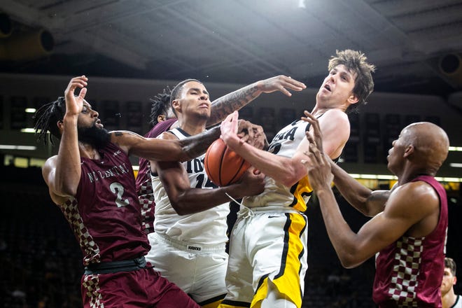 Iowa forwards Keegan Murray, second from left, and Patrick McCaffery, second from right, attempt to pull down a rebound against North Carolina Central's Kris Monroe, left, and Marque Maultsby during a NCAA non-conference men's basketball game, Tuesday, Nov. 16, 2021, at Carver-Hawkeye Arena in Iowa City, Iowa.