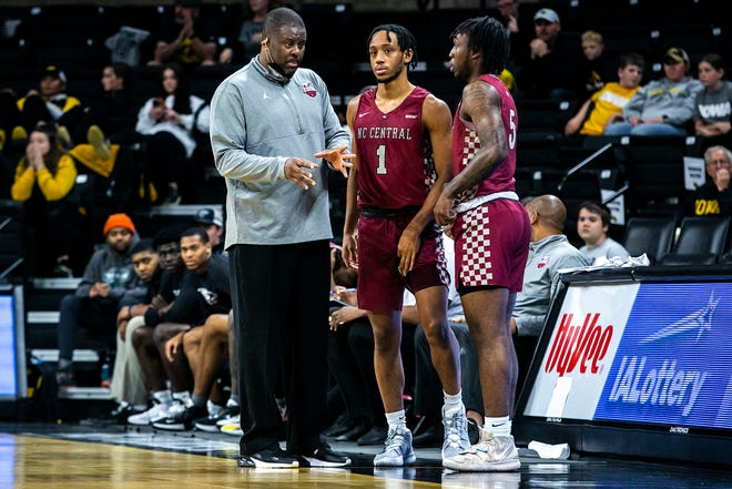 North Carolina Central head coach LeVelle Moton, left, talks with players Ja'Darius Harris (1) and Justin Wright during a NCAA non-conference men's basketball game against Iowa, Tuesday, Nov. 16, 2021, at Carver-Hawkeye Arena in Iowa City, Iowa.
