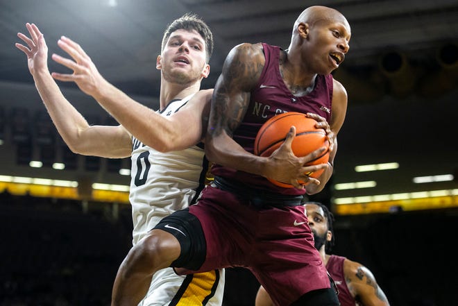 North Carolina Central's Marque Maultsby, right, pulls down a rebound against Iowa forward Filip Rebraca during a NCAA non-conference men's basketball game, Tuesday, Nov. 16, 2021, at Carver-Hawkeye Arena in Iowa City, Iowa.