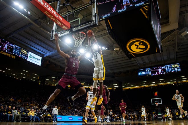 Iowa forward Keegan Murray (15) dunks the ball as North Carolina Central's Kris Monroe, left, defends during a NCAA non-conference men's basketball game, Tuesday, Nov. 16, 2021, at Carver-Hawkeye Arena in Iowa City, Iowa.