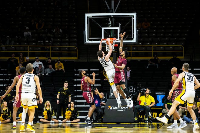 Iowa forward Patrick McCaffery (22) dunks the ball against North Carolina Central's Dontavius King during a NCAA non-conference men's basketball game, Tuesday, Nov. 16, 2021, at Carver-Hawkeye Arena in Iowa City, Iowa.