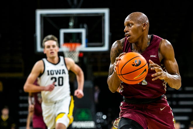 North Carolina Central's Marque Maultsby, right, drives to the basket during a NCAA non-conference men's basketball game against Iowa, Tuesday, Nov. 16, 2021, at Carver-Hawkeye Arena in Iowa City, Iowa.