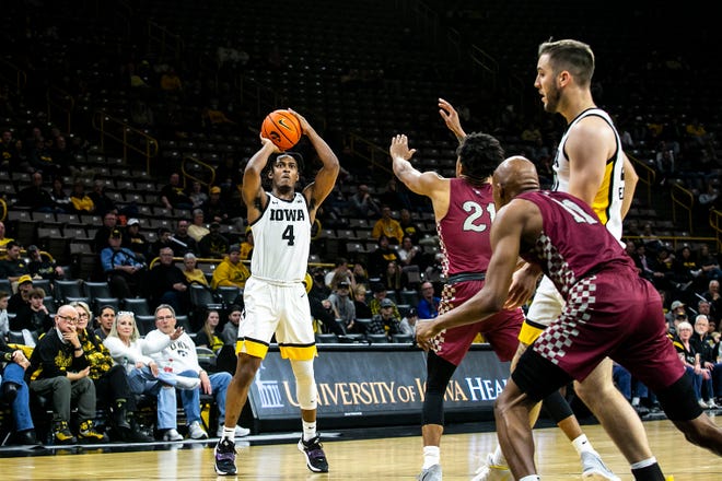 Iowa guard Ahron Ulis (4) makes a 3-point basket during a NCAA non-conference men's basketball game against North Carolina Central, Tuesday, Nov. 16, 2021, at Carver-Hawkeye Arena in Iowa City, Iowa.