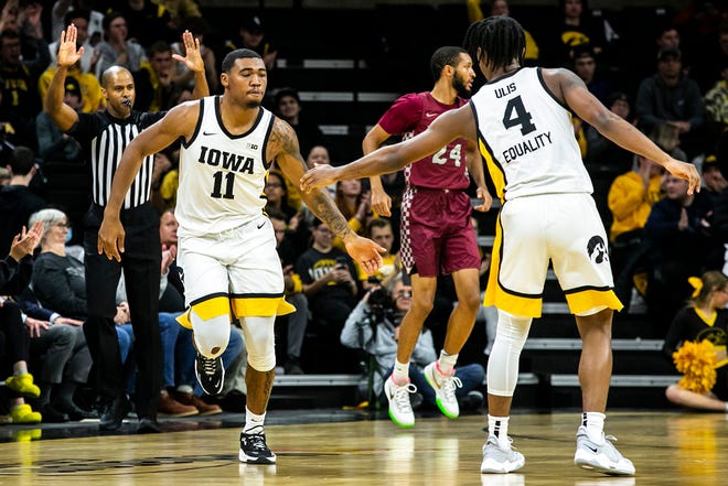 Iowa guard Tony Perkins (11) celebrates with Iowa guard Ahron Ulis (4) after making a 3-point basket during a NCAA non-conference men's basketball game against North Carolina Central, Tuesday, Nov. 16, 2021, at Carver-Hawkeye Arena in Iowa City, Iowa.