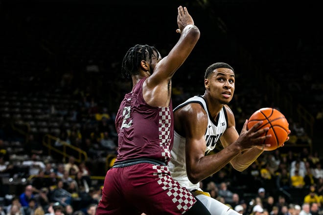 Iowa forward Keegan Murray (15) drives to the basket as North Carolina Central's Kris Monroe, left, defends during a NCAA non-conference men's basketball game, Tuesday, Nov. 16, 2021, at Carver-Hawkeye Arena in Iowa City, Iowa.