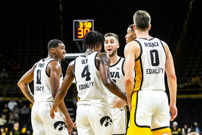 Iowa players, from left, Tony Perkins, Ahron Ulis, Connor McCaffery, Keegan Murray and Filip Rebraca huddle up during a NCAA non-conference men's basketball game against North Carolina Central, Tuesday, Nov. 16, 2021, at Carver-Hawkeye Arena in Iowa City, Iowa.
