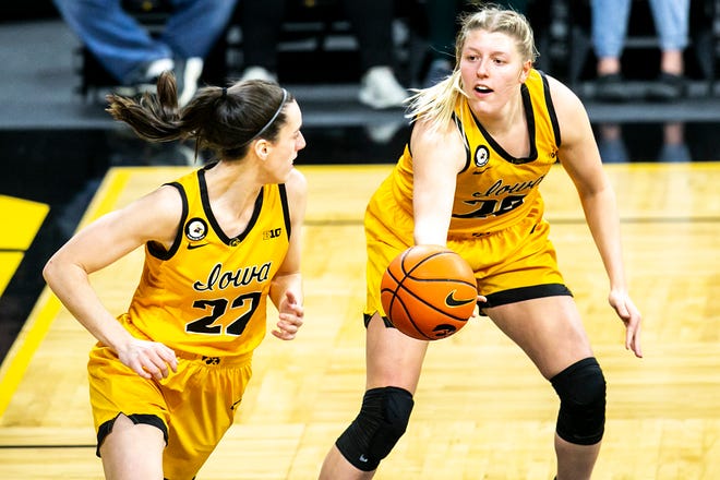 Iowa center Monika Czinano, right, passes the ball to Iowa guard Caitlin Clark (22) during a NCAA non-conference women's basketball game against Southern Unviersity, Wednesday, Nov. 17, 2021, at Carver-Hawkeye Arena in Iowa City, Iowa.
