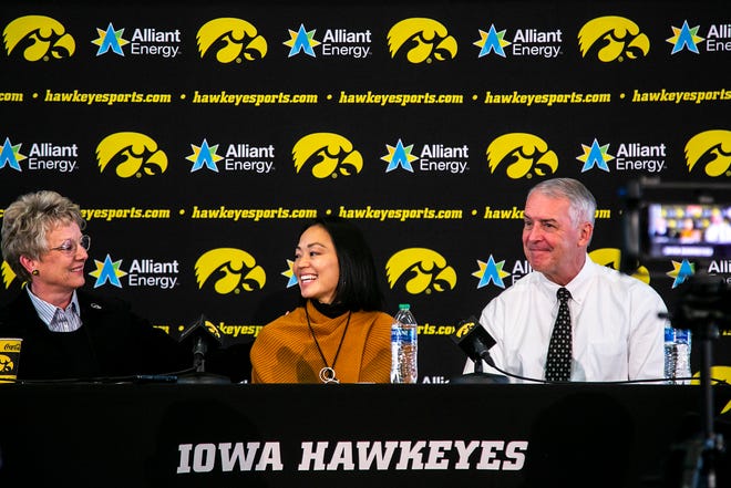 Barbara Burke, University of Iowa's deputy director of athletics, left, Clarissa Chun, center, and Iowa athletic director Gary Barta smile during a news conference announcing Chun as the inaugural head coach for the women's wrestling program, Friday, Nov. 19, 2021, at Carver-Hawkeye Arena in Iowa City, Iowa.