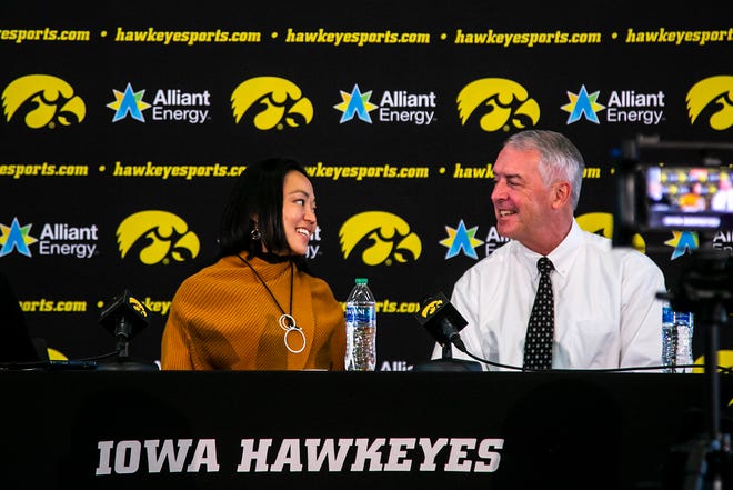 Clarissa Chun, left, listens to Iowa athletic director Gary Barta speak during a news conference announcing Chun as the inaugural head coach for the women's wrestling program, Friday, Nov. 19, 2021, at Carver-Hawkeye Arena in Iowa City, Iowa.