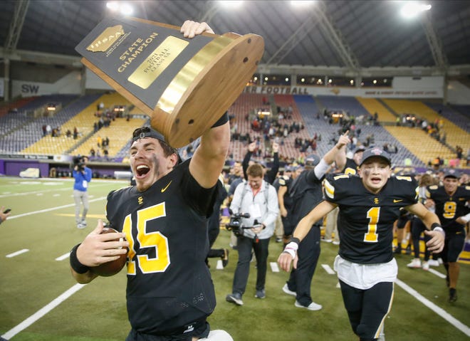 Southeast Polk senior quarterback Jaxon Dailey celebrates with the Class 5A state football trophy after helping the Rams to a 24-7 win over Ankeny during the Iowa High School Class 5A state championship football game at the UNI-Dome in Cedar Falls on Friday, Nov. 19, 2021.