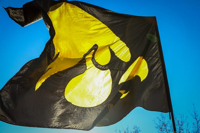 A tailgater’s Hawkeye flag is seen waving in the wind before the Iowa football game against Illinois in Iowa City on Sat., Nov. 20, 2021.