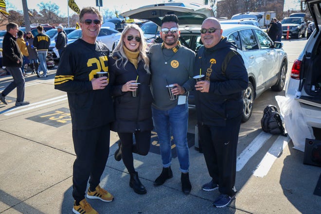 Left to right: Rob Best, Chloe Challenger, Bryan Gamboa and Jim Dilley, of Des Moines, tailgate outside Kinnick Stadium before the Iowa football game against Illinois in Iowa City on Sat., Nov. 20, 2021.