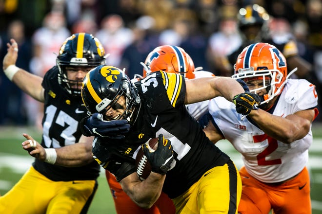 Iowa linebacker Jack Campbell (31) sheds a tackle from Illinois running back Chase Brown (2) while running an intercepted pass back for a touchdown during a NCAA Big Ten Conference football game, Saturday, Nov. 20, 2021, at Kinnick Stadium in Iowa City, Iowa.