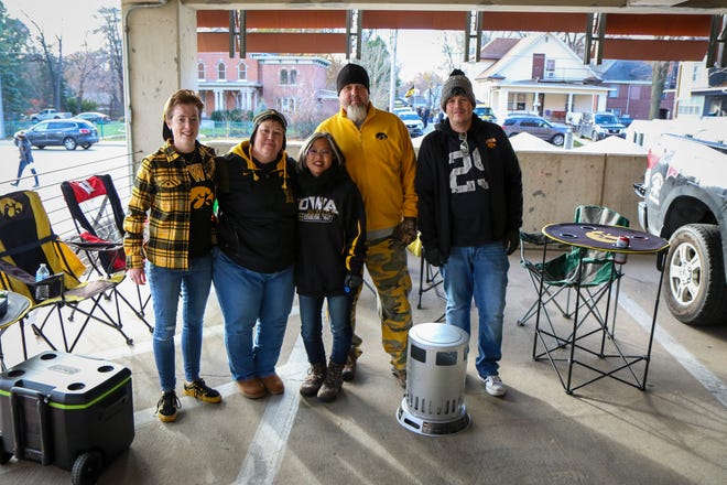 Left to right: Terra Wilson, Lynne Hoffmann, Susie and Rob Kishiue- Koval and Steve Barker, of Cedar Rapids, tailgate before the Iowa football game against Illinois in Iowa City on Sat., Nov. 20, 2021.