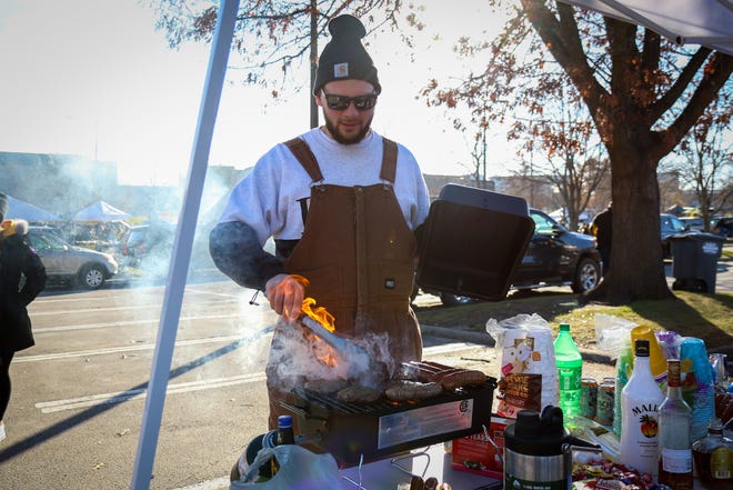 Robert Janssen, of Parkersburg, grills up some brats while tailgating before the Iowa football game against Illinois in Iowa City on Sat., Nov. 20, 2021.