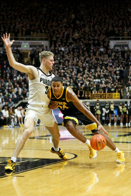 Iowa forward Kris Murray (24) dribbles against Purdue forward Caleb Furst (3) during the first half of an NCAA men's basketball game, Friday, Dec. 3, 2021 at Mackey Arena in West Lafayette.