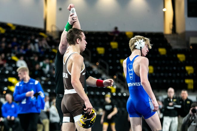 Mount Carmel's Sergio Lemley, left, has his hand raised after beating Waukee Northwest's Carter Freeman at 126 pounds during the finals of the Dan Gable Donnybrook high school wrestling tournament, Saturday, Dec. 4, 2021, at the Xtream Arena in Coralville, Iowa.