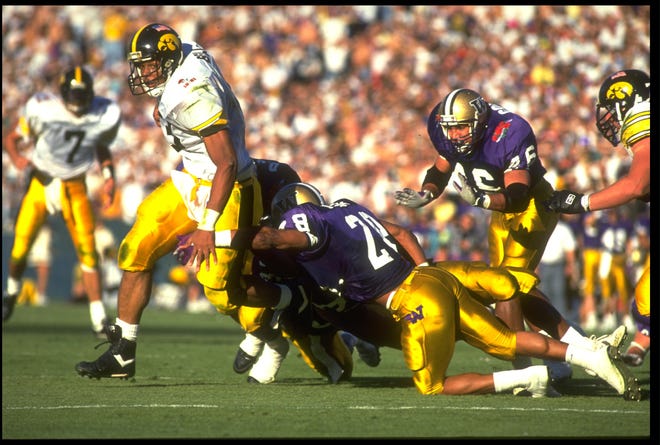 Nick Bell of the University of Iowa tries to break free from a tackle from Washington during the Hawkeyes' 46-34, loss to the Huskies in the Rose Bowl, Jan. 1, 1991, in Pasadena, Cali.