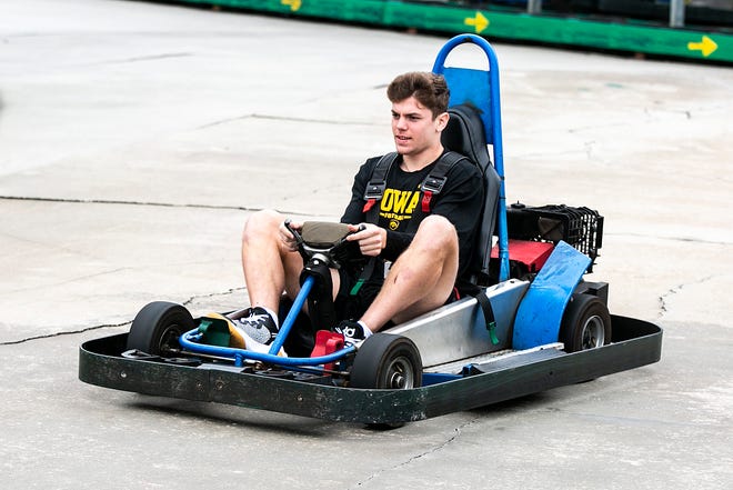 Iowa defensive back Cooper DeJean drives around a track during their day off before the Citrus Bowl football game, Thursday, Dec. 30, 2021, at Fun Spot America in Orlando, Fla.
