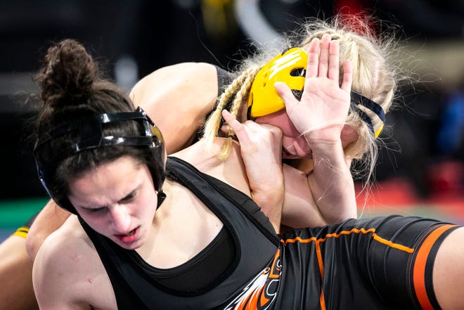Bettendorf's Ella Schmit, right, wrestles Cedar Rapids Prairie's Mackenzi Childers at 125 pounds during the second session of the Iowa Wrestling Coaches and Officials Association (IWCOA) girls' state wrestling tournament, Saturday, Jan. 22, 2022, at the Xtream Arena in Coralville, Iowa.