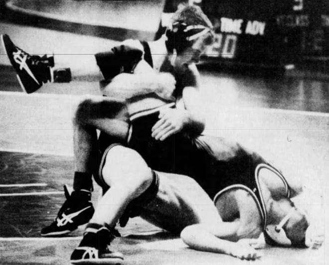 Iowa's Terry Brands, left, forces Oklahoma State's Tony Purler into the mat during Brands' 20-5 technical fall in the 1991 semifinals at Carver-Hawkeye Arena.