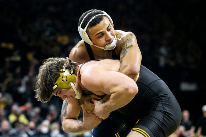 Penn State's Aaron Brooks, right, wrestles Iowa's Abe Assad at 184 pounds during a NCAA Big Ten Conference wrestling dual, Friday, Jan. 28, 2022, at Carver-Hawkeye Arena in Iowa City, Iowa.