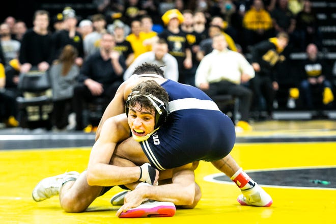 Iowa's Austin DeSanto, left, wrestles Penn State's Roman Bravo-Young at 133 pounds during a NCAA Big Ten Conference wrestling dual, Friday, Jan. 28, 2022, at Carver-Hawkeye Arena in Iowa City, Iowa.