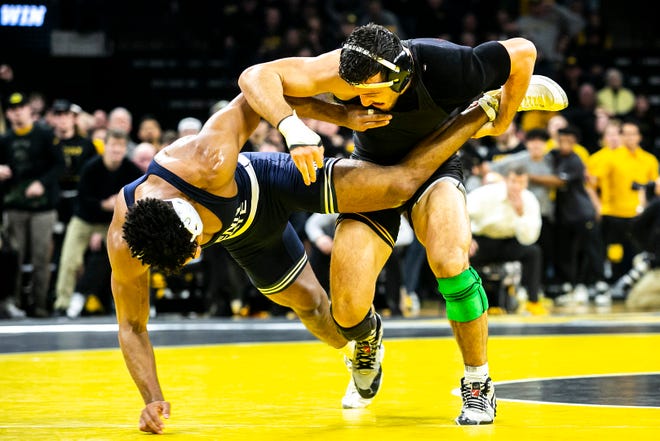 Iowa's Michael Kemerer, right, wrestles Penn State's Carter Starocci at 174 pounds during a NCAA Big Ten Conference wrestling dual, Friday, Jan. 28, 2022, at Carver-Hawkeye Arena in Iowa City, Iowa.