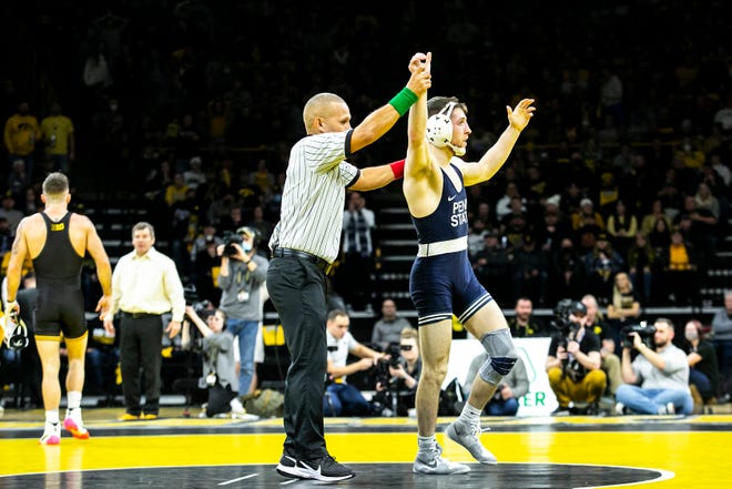 Penn State's Nick Lee, right, reacts after beating Iowa's Jaydin Eierman in sudden victory at 141 pounds during a NCAA Big Ten Conference wrestling dual, Friday, Jan. 28, 2022, at Carver-Hawkeye Arena in Iowa City, Iowa.