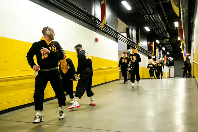 Iowa wrestlers run down the tunnel before a NCAA Big Ten Conference wrestling dual against Penn State, Friday, Jan. 28, 2022, at Carver-Hawkeye Arena in Iowa City, Iowa.