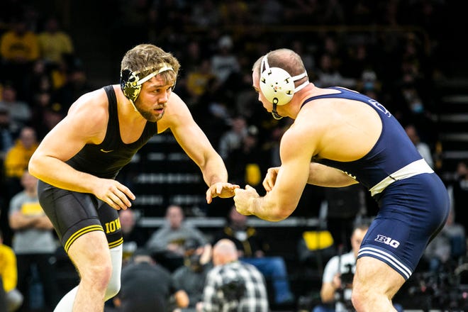 Iowa's Jacob Warner, left, wrestles Penn State's Max Dean at 197 pounds during a NCAA Big Ten Conference wrestling dual, Friday, Jan. 28, 2022, at Carver-Hawkeye Arena in Iowa City, Iowa.