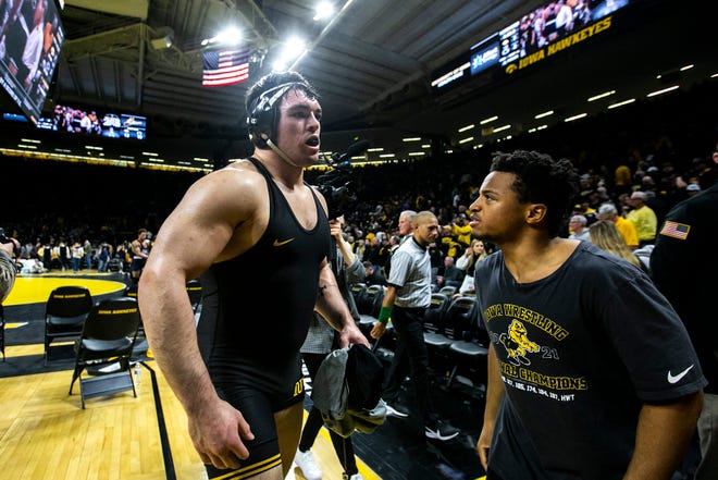 Iowa's Tony Cassioppi, left, is greeted by teammates after his decision win at 285 pounds during a NCAA Big Ten Conference wrestling dual, Friday, Jan. 28, 2022, at Carver-Hawkeye Arena in Iowa City, Iowa.