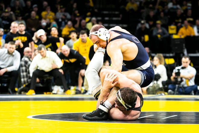 Penn State's Max Dean, top, wrestles Iowa's Jacob Warner at 197 pounds during a NCAA Big Ten Conference wrestling dual, Friday, Jan. 28, 2022, at Carver-Hawkeye Arena in Iowa City, Iowa.