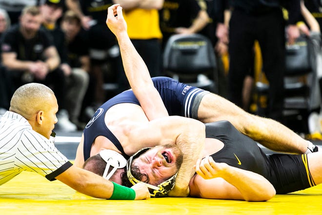 Penn State's Max Dean, top, wrestles Iowa's Jacob Warner at 197 pounds during a NCAA Big Ten Conference wrestling dual, Friday, Jan. 28, 2022, at Carver-Hawkeye Arena in Iowa City, Iowa.