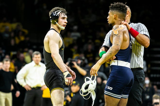 Iowa's Austin DeSanto, left, talks with Penn State's Roman Bravo-Young after their match at 133 pounds during a NCAA Big Ten Conference wrestling dual, Friday, Jan. 28, 2022, at Carver-Hawkeye Arena in Iowa City, Iowa.