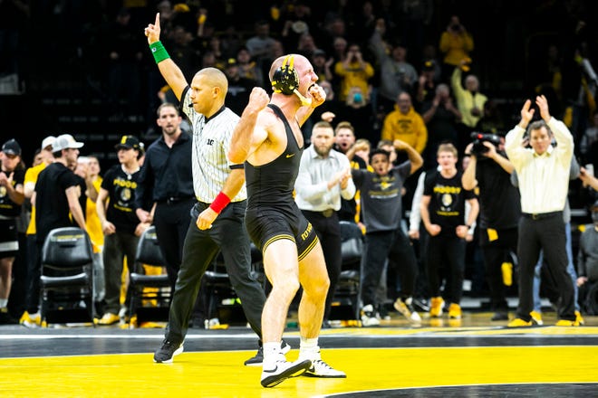 Iowa's Alex Marinelli, right, reacts after scoring a major decision at 165 pounds during a NCAA Big Ten Conference wrestling dual against Penn State, Friday, Jan. 28, 2022, at Carver-Hawkeye Arena in Iowa City, Iowa.