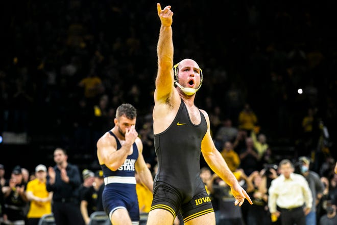 Iowa's Alex Marinelli, right, reacts after scoring a major decision at 165 pounds during a NCAA Big Ten Conference wrestling dual against Penn State, Friday, Jan. 28, 2022, at Carver-Hawkeye Arena in Iowa City, Iowa.