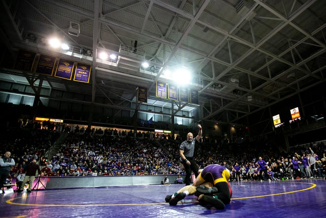 An official signals for stalling on Iowa State's Kysen Terukina, bottom, as he wrestles Northern Iowa's Brody Teske at 125 pounds during a NCAA college Big 12 wrestling dual, Friday, Feb. 11, 2022, at the McLeod Center in Cedar Falls, Iowa.