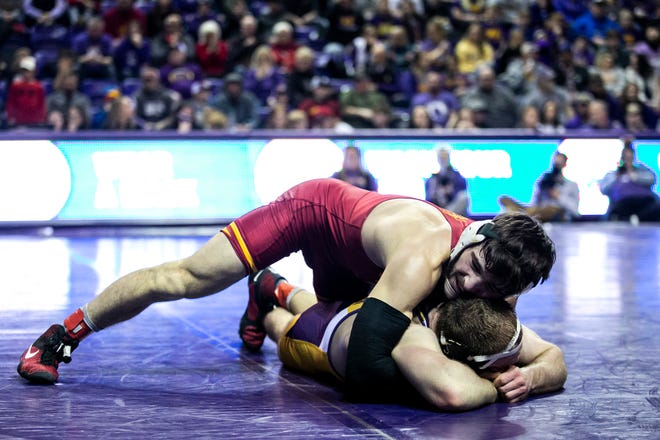 Iowa State's Ian Parker, top, wrestles Northern Iowa's Cael Happel at 141 pounds during a NCAA college Big 12 wrestling dual, Friday, Feb. 11, 2022, at the McLeod Center in Cedar Falls, Iowa.