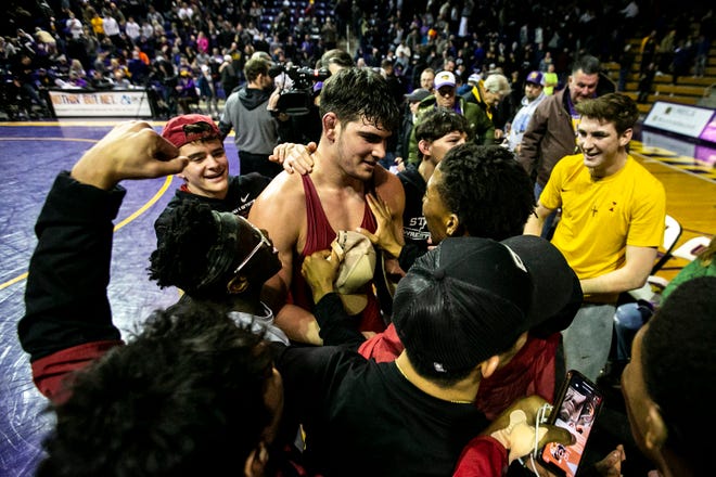 Iowa State's Sam Schuyler is embraced by teammates after scoring a decision at 285 pounds during a NCAA college Big 12 wrestling dual against Northern Iowa, Friday, Feb. 11, 2022, at the McLeod Center in Cedar Falls, Iowa.